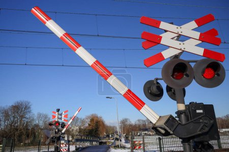 Photo for Railway crossing with red lights and barrier in the Zuidplaspolder the netherlands - Royalty Free Image