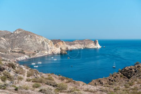 View with boats of the coast of Akrotiri and the black sand beach that is known locally as Mesa Pigadia beach. Greek Islands, Santorini, European Vacation