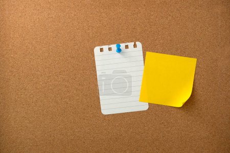 Blank sticky note paper on cork board wall. Noticeboard to organize life and work concept 