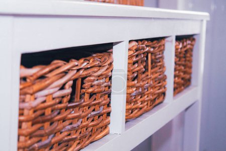 Wicker baskets on a shelf in a store, close-up