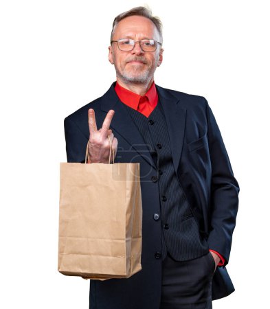 Foto de Social responsibility concept. Man hand supporting empty paper bag and deny plastic bag for shopping time on a white background. Showing victory sign - Imagen libre de derechos