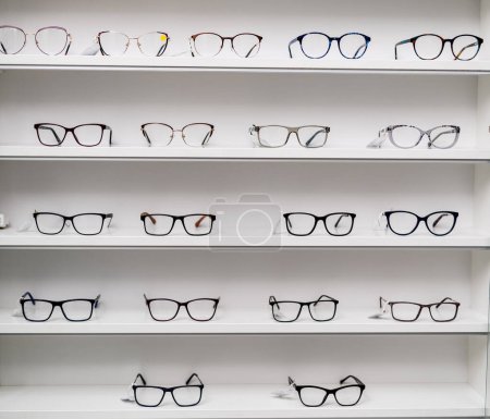 Eyeglasses stand in store. Eye accessories in shopping stand.