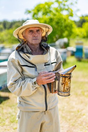 Photo for An old man in a hat holding a bucket - Royalty Free Image
