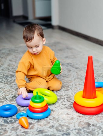 Photo for A Playful Toddler Engaged in Imaginative Play. A toddler playing with toys on the floor - Royalty Free Image