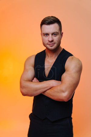 Photo for A man with his arms crossed posing for a picture. A Confident Man Striking a Pose With His Arms Crossed - Royalty Free Image