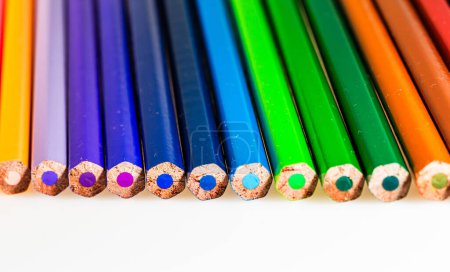 Téléchargez les photos : Un spectre vibrant de crayons de couleur disposés dans une rangée parfaitement alignée. Un groupe de crayons de couleur alignés dans une rangée - en image libre de droit