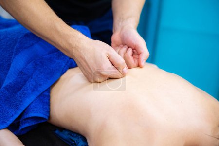 Photo for Man Receiving Professional Back Massage for Relaxation and Stress Relief - Royalty Free Image