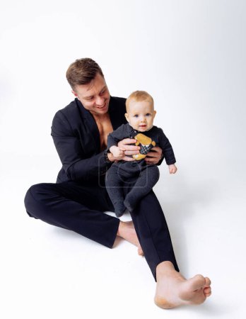 Téléchargez les photos : L'homme tenant son bébé à la main, un moment doux d'amour et de soins paternels - en image libre de droit