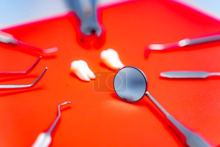 Photo for Dental instruments and tools on red background - Royalty Free Image