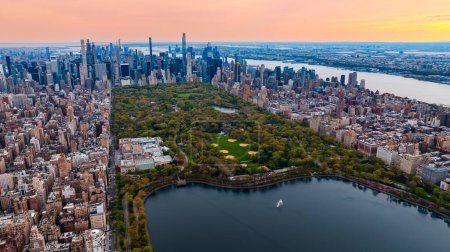 Scenic view of Central Park in the cityscape of New York, the USA. Aerial perspective. Enormous city panorama at sunset.