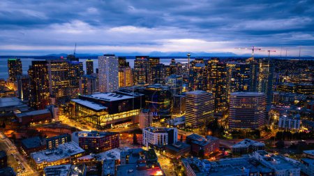 Splendid scenery of the vibrant downtown of Seattle, Washington, the USA. Blue waterscape and evening night at backdrop.