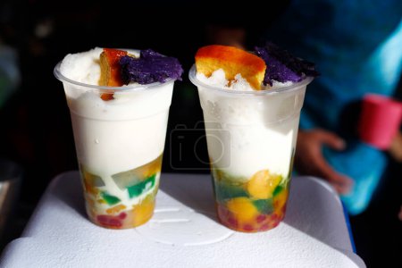 Photo of freshly made Filipino snack and dessert food called Halo Halo made up of shaved ice and assorted sweets.