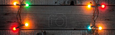 Photo for Christmas Lights on Wooden Rustic Background. Christmas Eve and New Year Thematic Mockup Wallpaper for Clipart. - Royalty Free Image