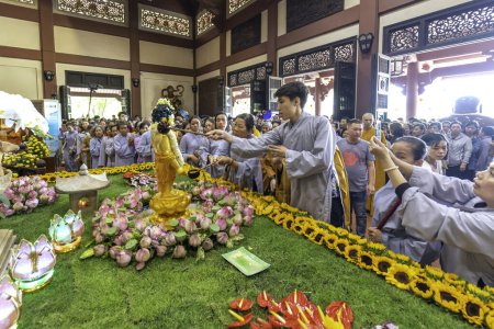 Photo for Ho Chi Minh City, Vietnam - May 19th, 2019: Group of Vietnamese Buddhist bath Buddha statue purify body and spirit in Buddha birthday celebration at pagoda in Ho Chi Minh City, Vietnam - Royalty Free Image