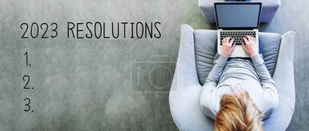 Photo for 2023 Resolutions with man using a laptop in a modern gray chair - Royalty Free Image