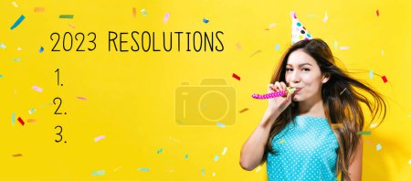 Photo for 2023 Resolutions with young woman with party theme on a yellow background - Royalty Free Image