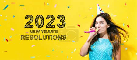 Photo for 2023 New Years Resolutions with young woman with party theme on a yellow background - Royalty Free Image