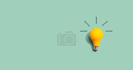 Photo for Yellow light bulb - flat lay from above - Royalty Free Image