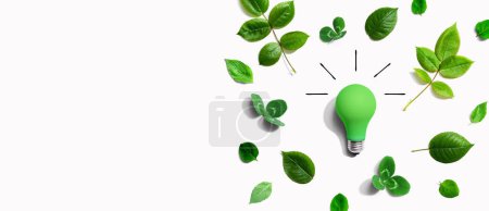 Photo for Green light bulb with green leaves - Flat lay - Royalty Free Image