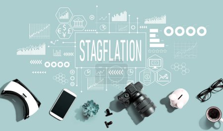 Stagflation theme with electronic gadgets and office supplies - flat lay
