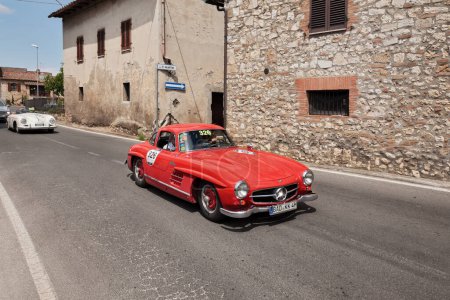 Photo for Vintage sports car Mercedes-Benz 300 SL W 198 (1955) runs in Tuscan village during the classic car race Mille Miglia. May 17, 2014 in Colle di Val d'Elsa, SI, Italy - Royalty Free Image