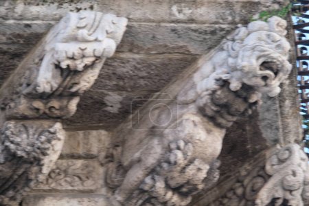 City Hall building, Loggia Giuratoria, anthropomorphic and zoomorphic corbels, mascarons and reliefs under a balcony, Acireale, Sicily, Italy