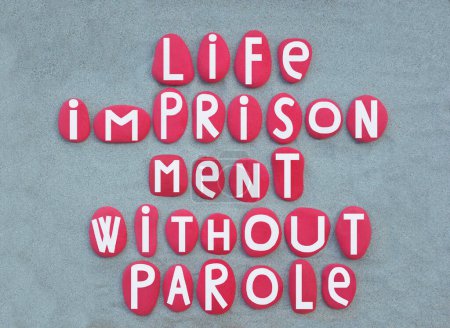 Life imprisonment is any sentence of imprisonment for a crime under which convicted criminals are to remain in prison for the rest of their natural lives, creative text composed with hand painted red colored stone letters over green sand