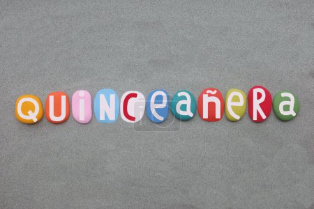 Quinceanera, a celebration of a girl's 15th birthday that is common in Mexican and other Latin American cultures, creative text composed with hand painted multi colored stone letters over green sand