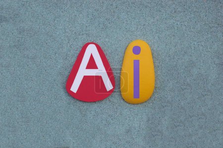 AI, signe d'intelligence artificielle composé de lettres de pierre multicolores peintes à la main sur du sable vert