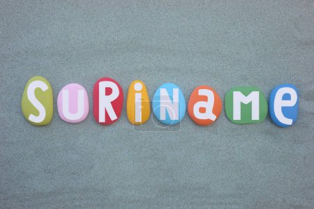 Suriname,  country in northern South America, souvenir composed with hand painted multi colored stone letters over green sand