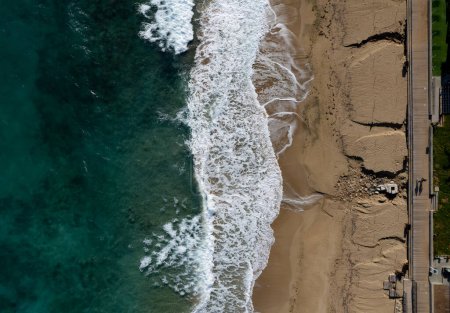 Photo for Aerial view of ocean waves breaking on a sandy beach. Beach erosion after coastal flooding. Protaras Cyprus. - Royalty Free Image