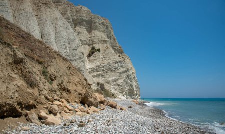 Rocky cliff in the ocean. A long and narrow stretch beach with a rocky shoreline. Limassol Cyprus
