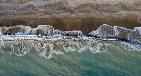 Photo for Aerial view of stormy ocean waves breaking on a sandy beach. Nature background. - Royalty Free Image