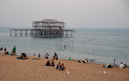 Photo for Brighton, United Kingdom, June 10 2023: Crowd of British people sunbathing swimming and relaxing in the beach at summer. Leisure time outdoor - Royalty Free Image