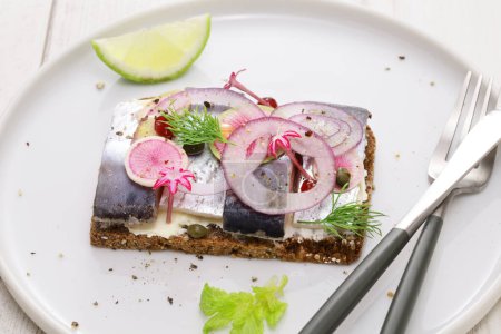 Photo for Pickled herring Smorrebrod, Danish open faced sandwich - Royalty Free Image