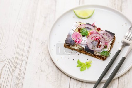 Photo for Pickled herring Smorrebrod, Danish open faced sandwich - Royalty Free Image