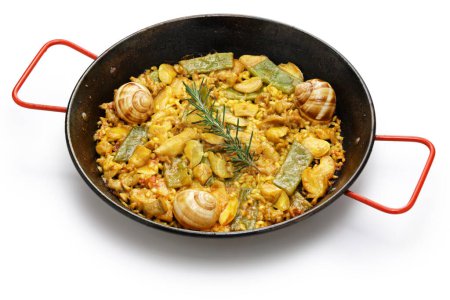 Photo for Paella Valenciana (Spanish traditonal rice dish); rabbit, chicken, garrofon beans, snails, Moroccan green beans, saffron, and bomba rice. - Royalty Free Image