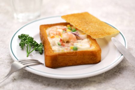 Téléchargez les photos : Pain de cercueil, nourriture taïwanaise C'est pain blanc qui a été frit dans l'huile, avec le centre creusé et farci avec de la chaudrée de fruits de mer. - en image libre de droit