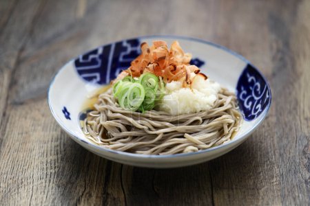 Oroshi soba, Japanese chilled buckwheat noodles topped with grated daikon radish is eaten with soba soup.