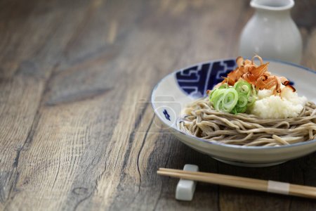 Oroshi soba, Japanese chilled buckwheat noodles topped with grated daikon radish is eaten with soba soup.