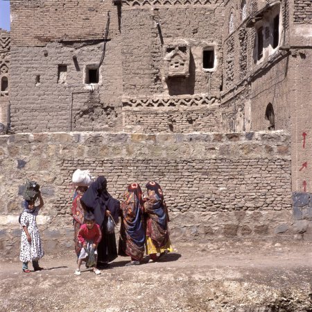 Photo for SANA'A, YEMEN- APRIL 12, 2019: Women with children and dressed with veils talking to each other on a street in the capital - Royalty Free Image