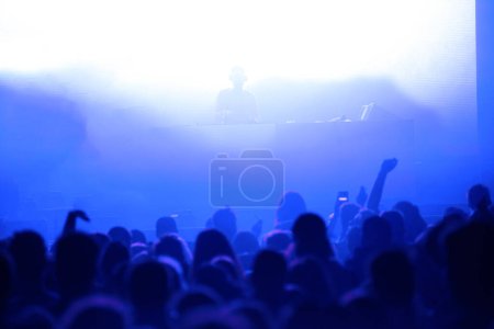 Photo for Crowd of people partying at live concert in the disco - Royalty Free Image