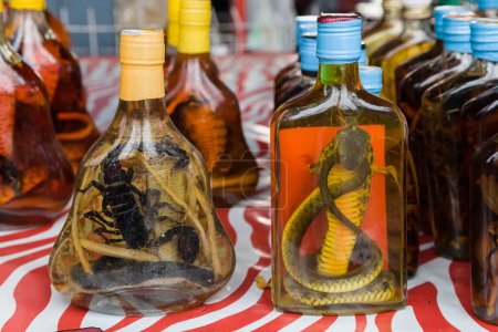 Photo for Lao-Lao whisky with snake and scorpion on display at the Don Sao Island market, Golden Triangle, Laos. - Royalty Free Image