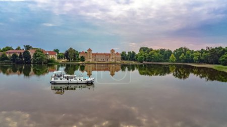 Photo for Houseboat in Rheinsberger lake near Rheinsberg palace aerial view from above, family travel by barge boat and vacation in lake district, Germany - Royalty Free Image