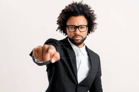 Foto de Confident serious male manager in formal wear pointing finger at the camera standing isolated on white, unpleasant supervisor choosing you, makes someone responsible for project problems, advertising - Imagen libre de derechos