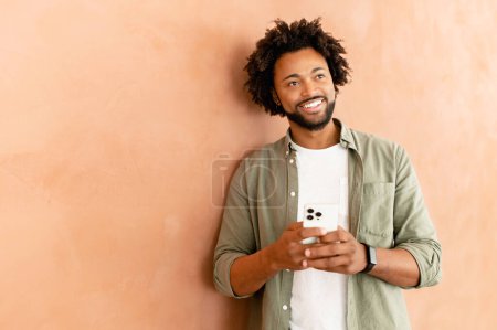 Photo for Carefree businessman using phone standing in modern office, cheerful friendly male employee texting online on mobile phone, chatting in social networks, web surfing - Royalty Free Image