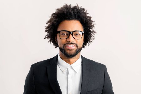 Photo for Close-up portrait of middle-aged curly african-american businessman in formal office suit and elegant eyeglasses looking at camera smiling isolated on white, profile photo of manager or male employee - Royalty Free Image
