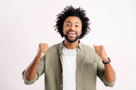 Extremely excited overjoyed man with beard shouting making yes gesture, amazed with his victory, triumph. Indoor studio shot isolated on white background