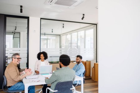 Photo for Diverse team of professionals gathers around a table for a collaborative session, where the exchange of innovative ideas promotes a co-working atmosphere that is both dynamic and inclusive, team work - Royalty Free Image