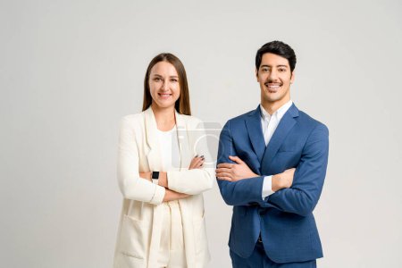 Photo for A professional male and female team, in sharp business attire, standing side by side with arms crossed. This image showcases the cooperative spirit and strategic planning - Royalty Free Image